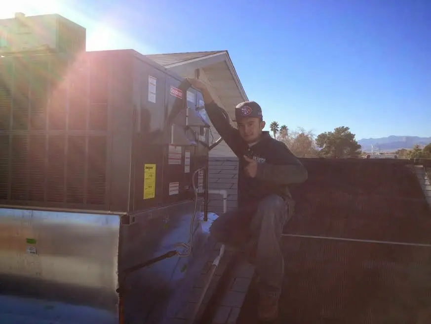 HVAC technician performing Heat Pump Repair on a rooftop unit in Mountain Home